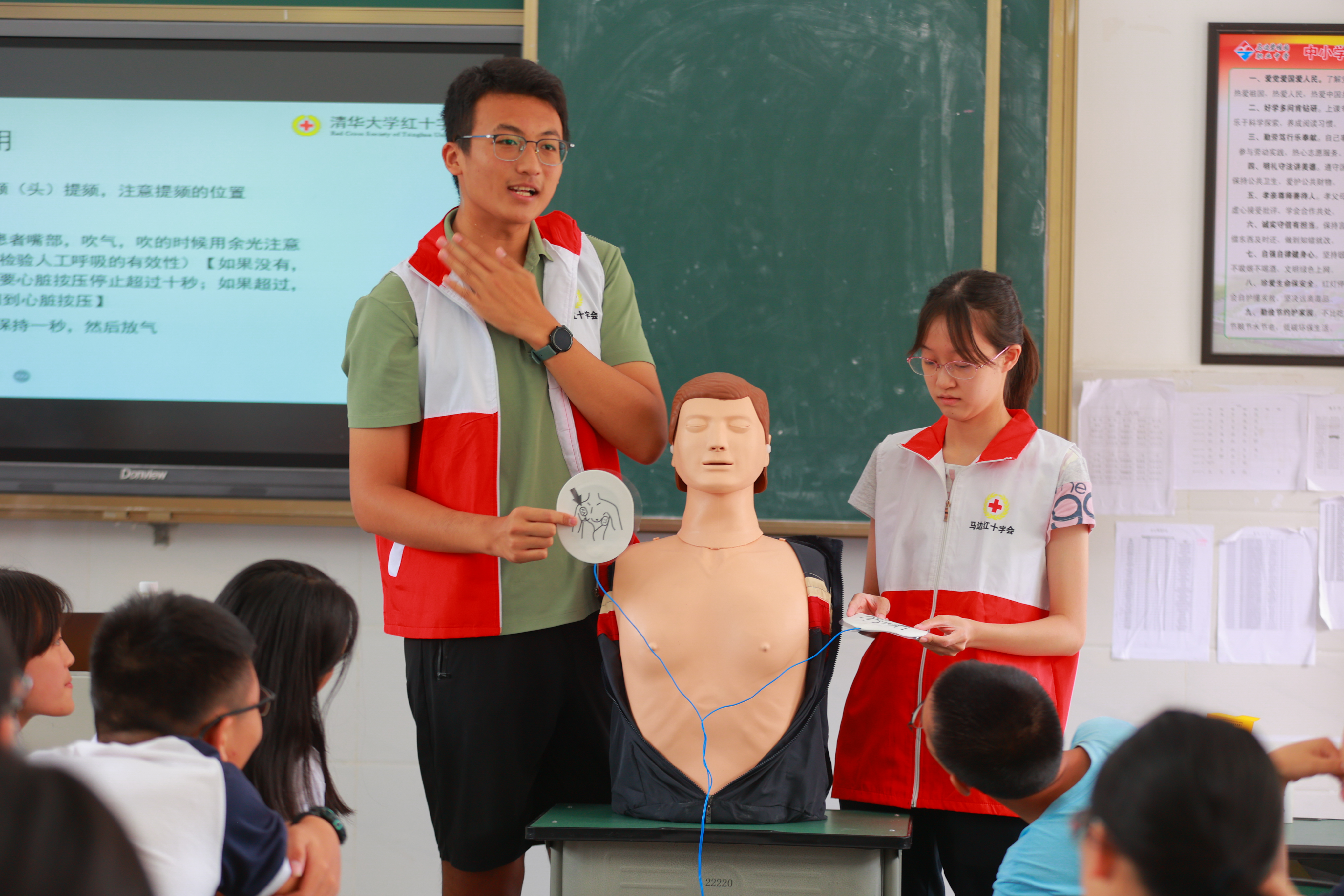 20220802-学生红会支教急救讲堂-郭镕玮-4 红会的老师和新葡萄学生红会的同学们正在讲解AED电极片粘贴位置、演示心肺复苏，同学们跃跃欲试(3).jpg